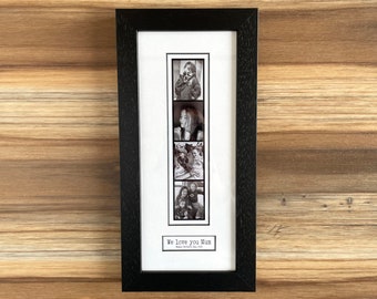 May include: A black framed photo collage featuring four black and white images. The collage includes the text "We love you Mum" and "Happy Mother's Day 2023". The frame is rectangular and sits on a wooden surface.