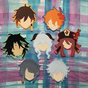 May include: Seven embroidered patches featuring anime characters with different hair colors and styles. The patches are on a purple and blue plaid fabric background.