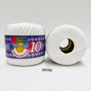May include: Two white balls of yarn with a purple label that says "Crochetta 10".