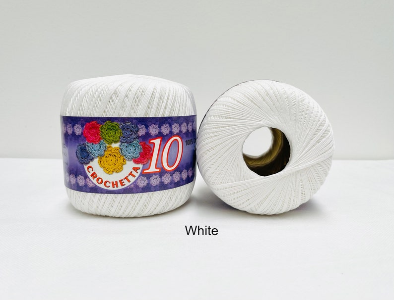May include: Two white balls of yarn with a purple label that says "Crochetta 10".