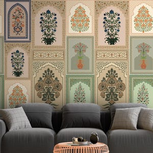May include: A living room with a dark grey sofa, a round coral coffee table, and a decorative wall with framed floral designs in muted tones. The room has a neutral colour palette with a touch of elegance.