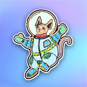 Chat sphynx astronaute. Autocollant holographique fait de vinyle. Holographic vinyl sticker. Sphynx cat astronaut.