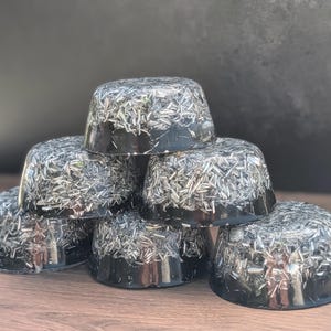 May include: A set of three ceramic mugs with a speckled, matte finish in cream, light grey, and dark grey. Each mug has a simple, modern design and a rounded handle.