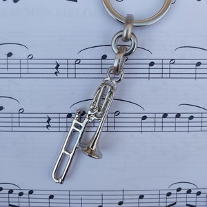 Trombone keychain. Silver trumpet, ideal as a gift. Trombone keychain.