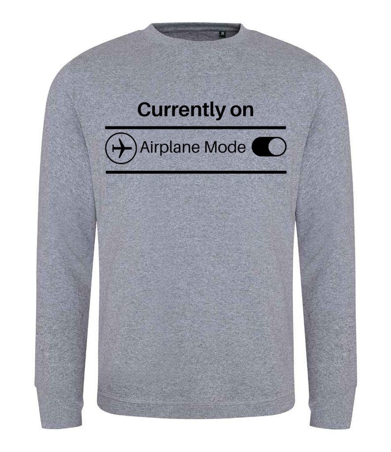 May include: A heather gray sweatshirt with the text "Currently on Airplane Mode" in black. The design includes an airplane icon and a toggle switch graphic, suggesting a playful reference to technology and travel.