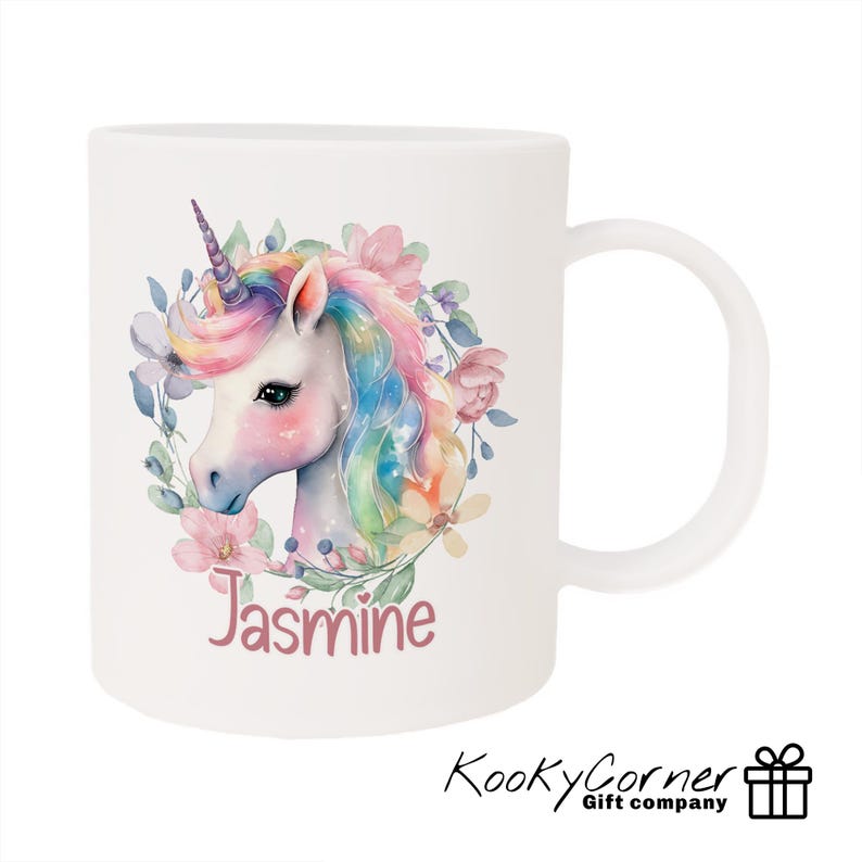 May include: White ceramic mug featuring a colourful unicorn illustration surrounded by flowers. The unicorn has a pink, blue and yellow mane and tail. The name "Jasmine" is printed below the unicorn.