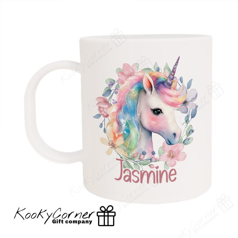 May include: White ceramic mug featuring a colourful unicorn illustration surrounded by flowers. The unicorn has a rainbow mane and tail. The mug is personalised with the name "Jasmine" printed on it.