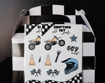 May include: Two white and black checkered favor boxes with a sticker on the front. The sticker has a black and white motorcycle, a wrench, a cone, a helmet, and a checkered flag. The text on the sticker reads "Shifting into 1st gear" and "Off road".
