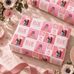 May include: Custom birthday wrapping paper featuring a repeating grid pattern of the name Ellie, the text Happy 6th Birthday, and the text 6 Today, interspersed with photographic images of a young girl wearing a crown and a blue denim jacket.