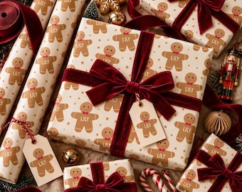 May include: Wrapping paper and gift boxes featuring a repeating pattern of brown gingerbread cookies with red bow ties and the name Lily printed on the chest. The gifts are tied with deep red velvet ribbon and include matching gift tags.