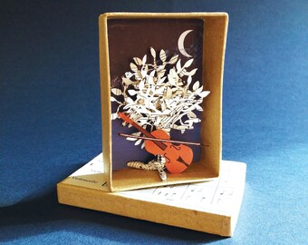Small decorative cardboard box with violin and paper tree
