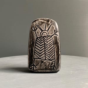 May include: A set of three ceramic mugs with a speckled, matte finish. The mugs are in cream, light grey, and dark grey. Each mug has a simple, minimalist design, ideal for coffee or tea.