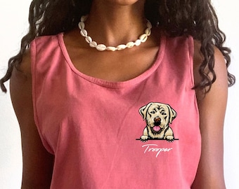 May include: A crimson sleeveless tank top featuring a graphic of a light-colored Labrador dog resting its paws on a horizontal line, with the name Trooper printed in white cursive script underneath the dog illustration on the left chest area.