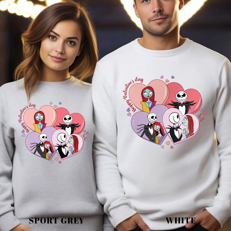 May include: Sport grey and white sweatshirts featuring a heart-shaped graphic with characters from The Nightmare Before Christmas. The design includes Jack Skellington, Sally, and other characters, with the text "Happy Valentine's Day".