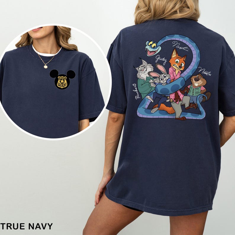 May include: True navy blue t-shirt with a Mickey Mouse police badge on the front and a Zootopia-themed graphic on the back. The back graphic features characters like Judy, Nick, and others, with a blue snake forming the number 2.