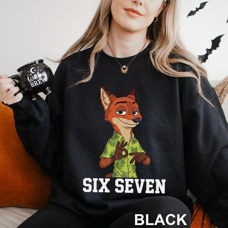 May include: Black sweatshirt featuring a cartoon fox character in a green Hawaiian shirt. The text "SIX SEVEN" is printed in white, with "BLACK" below. The fox is making an "okay" hand gesture.