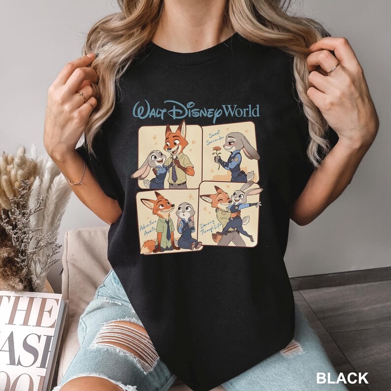 K&ouml;nnte beinhalten: Ein schwarzes T-Shirt mit dem Text Walt Disney World und vier illustrierten Feldern von Nick Wilde und Judy Hopps aus Zoomania. Die Felder zeigen die Figuren bei Interaktionen mit dem Text Sweet Surrender, Adventure Awaits und Dancing Through Life.