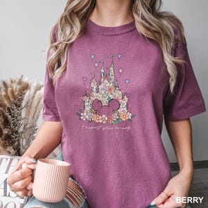 a woman is holding a cup of coffee