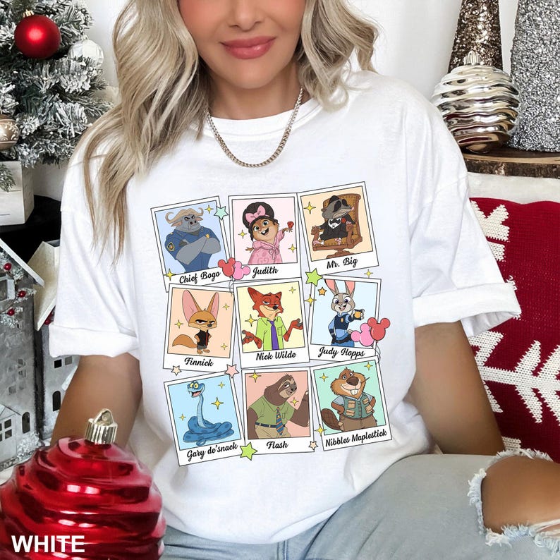 May include: White t-shirt featuring a grid of cartoon character portraits with names like "Chief Bogo," "Judy," and "Mr. Big." The shirt also has the word "WHITE" printed at the bottom.