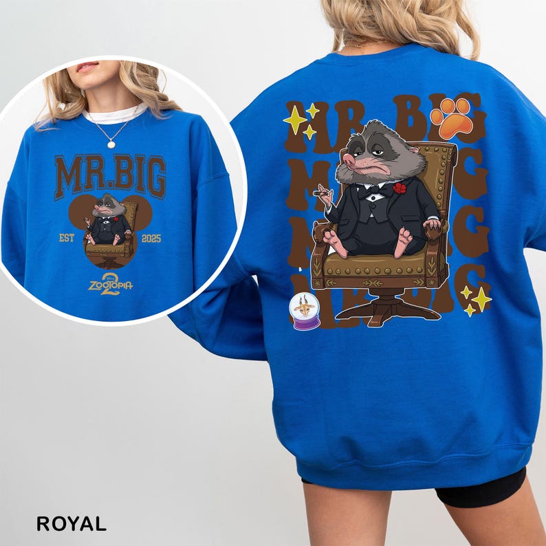 K&ouml;nnte beinhalten: K&ouml;nigsblaues Sweatshirt mit einer Cartoon-Illustration eines Charakters im Anzug, der auf einem Stuhl sitzt. Auf der Vorderseite des Sweatshirts steht der Text "MR. BIG" &uuml;ber der Charakterillustration, mit "EST 2025" und "Zootopia" darunter.
