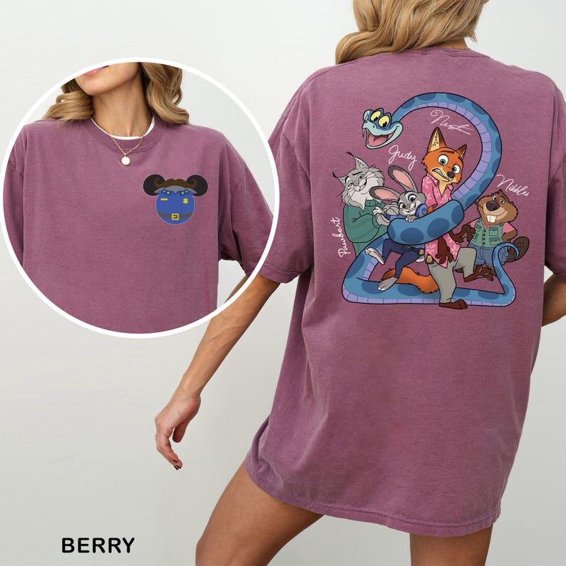 May include: Berry-coloured t-shirt with cartoon graphics on the front and back. The front graphic is a blue and yellow cartoon character. The back graphic features cartoon characters and the text "Judy", "Nick", and "Nibbles".