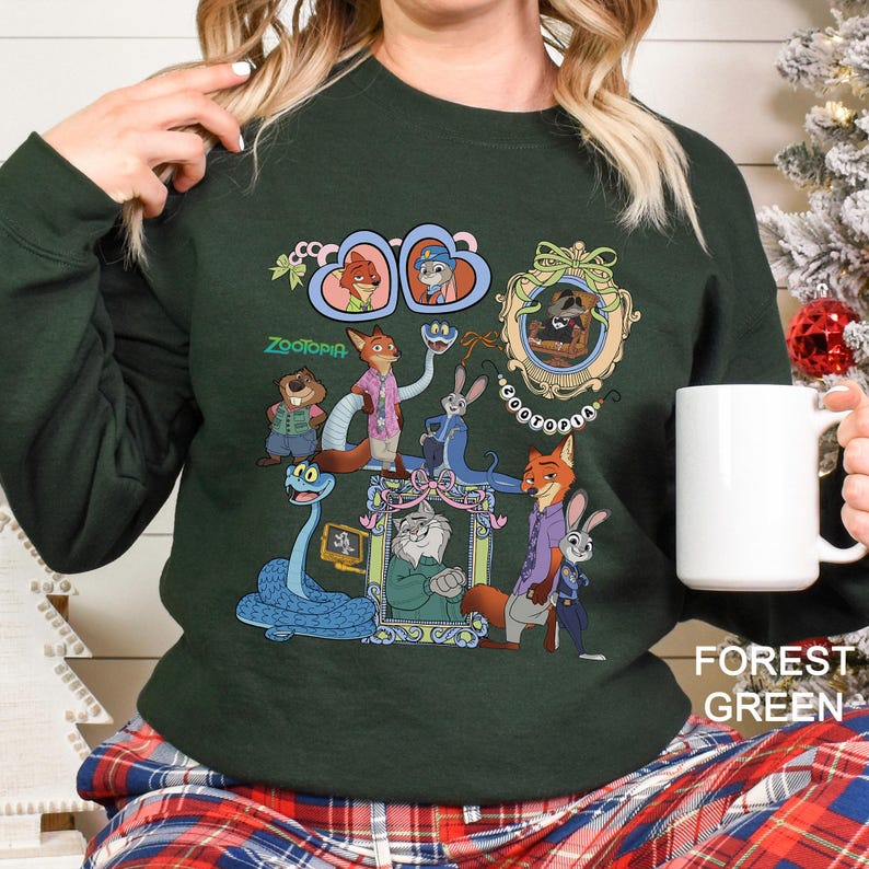May include: A forest green sweatshirt with a colourful graphic of Zootopia characters. The design includes framed portraits and the film's title. The sweatshirt is a solid colour.