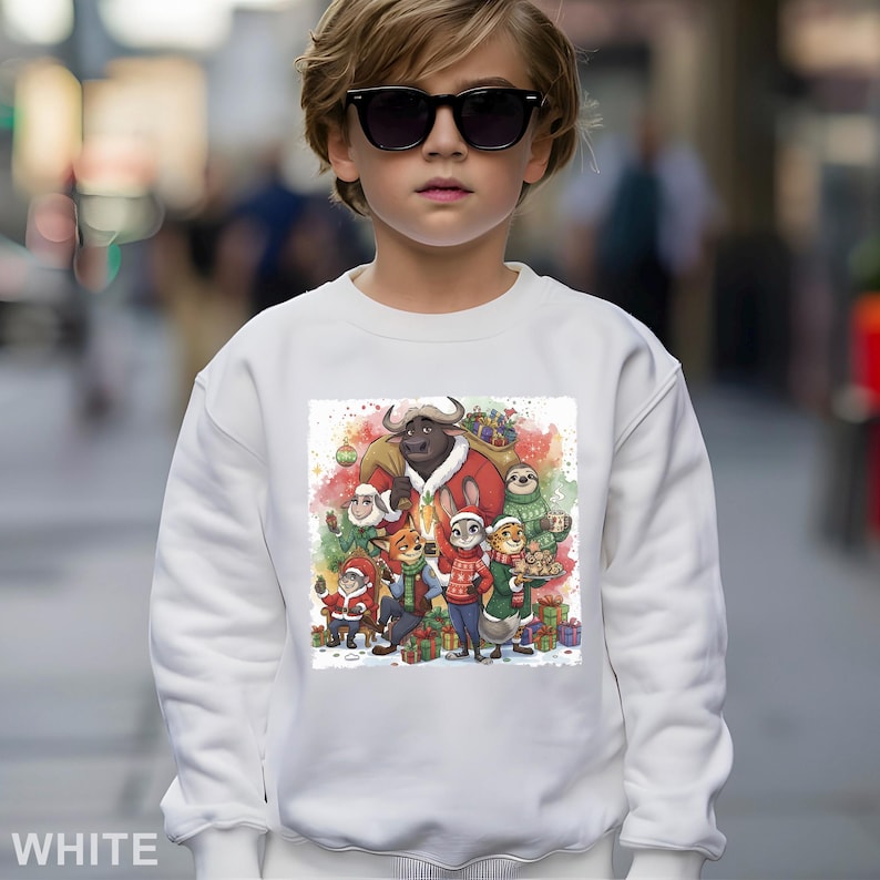 Op de afbeelding: Witte sweatshirt met een kleurrijke illustratie van stripfiguren in kerstoutfits, omringd door cadeaus. Een groot stierpersonage is verkleed als kerstman. Het woord "WHITE" staat onderaan.