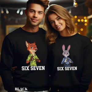 May include: Black sweatshirts featuring cartoon characters from Zootopia. One sweatshirt has a fox in a green shirt, the other has a bunny in a police uniform. Both sweatshirts have the text "SIX SEVEN" in white.