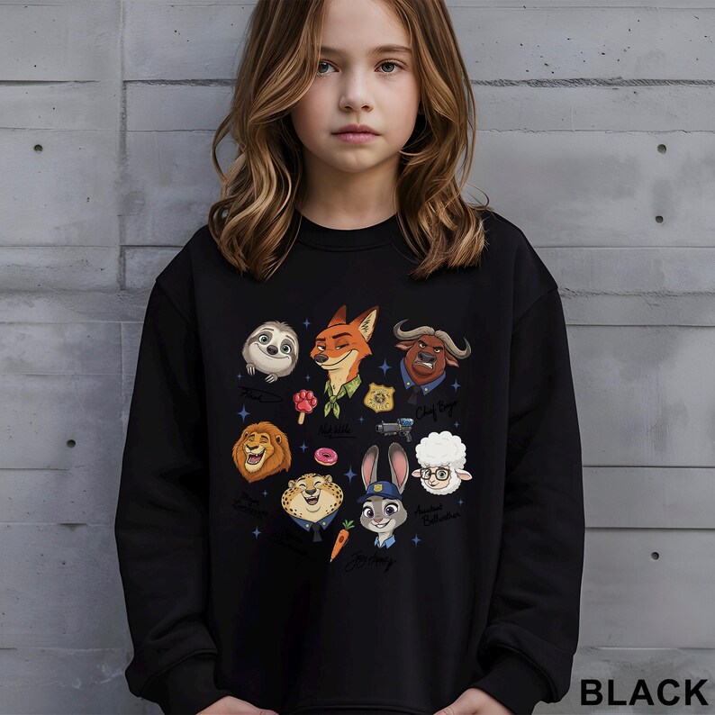 May include: Black sweatshirt featuring colorful cartoon characters from the movie Zootopia. The design includes Nick Wilde, Judy Hopps, and other characters. The word "BLACK" is printed at the bottom right corner of the sweatshirt.