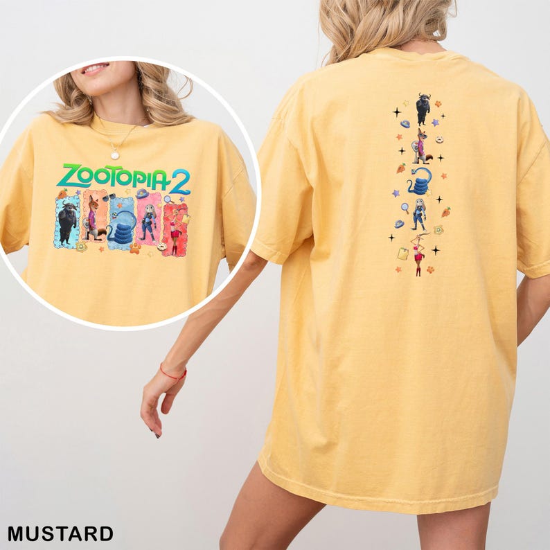 May include: Mustard-colored t-shirt featuring the text "ZOOTOPIA 2" with cartoon characters on the front. The back of the shirt has a vertical design with more cartoon characters. The shirt is a comfortable, oversized fit.