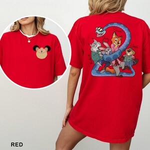 May include: Red t-shirt with a cartoon mouse face on the front and a group of cartoon characters with a blue snake on the back. The word "RED" is at the bottom of the image.