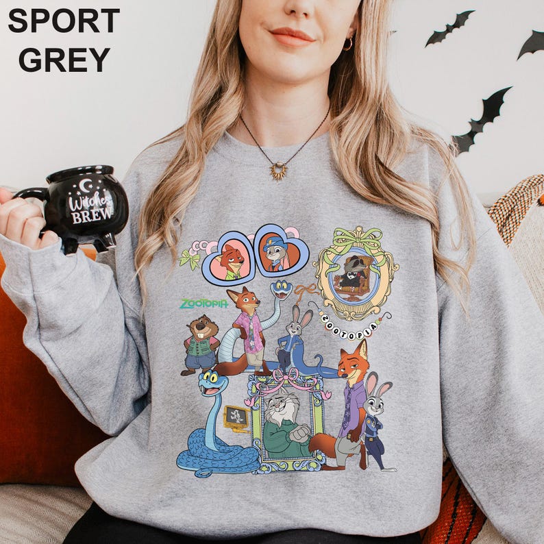 May include: Sport grey sweatshirt with a vibrant Zootopia character design. The illustration includes framed characters and a snake. The sweatshirt has the text "Zootopia" and "SPORT GREY" on it.