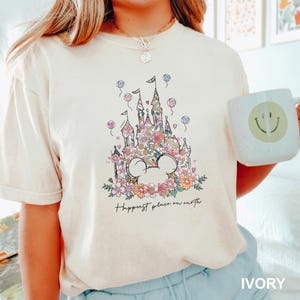 a woman holding a mug with a castle on it