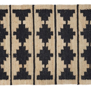 May include: A rectangular jute rug with a geometric pattern in black. The rug has a natural, earthy look and feel.