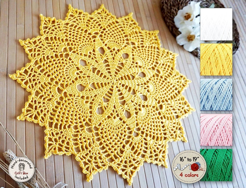 Crochet doily custom color and size in the shape of a 16-pointed star, with a very openwork texture forming a circle of original figures around the center, in the shape of eggs or pine cones.