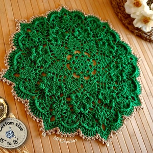 Hand crochet doily in bright emerald green edged with golden yarn. Thin thickness yarn creating creative embossed shamrocks in a circle around the center of the piece.