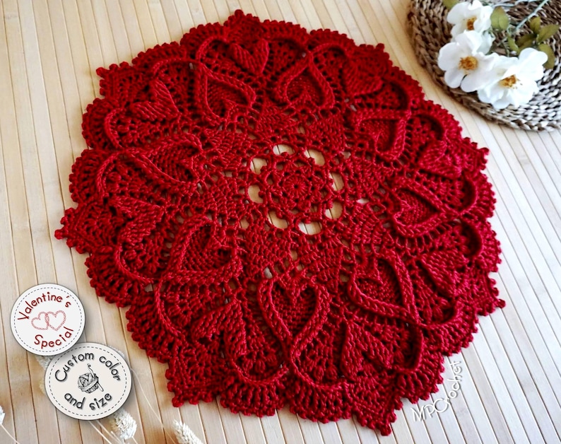 Dark red textured doily with hearts in relief. Customizable in various sizes between 19 and 25 inches in diameter and in deep red or white color. Hand crocheted with a stunning and slightly shiny egyptian cotton.