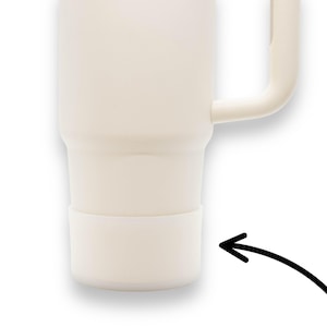 May include: A white ceramic mug with a handle and a white silicone base. The mug is designed to keep drinks hot or cold.