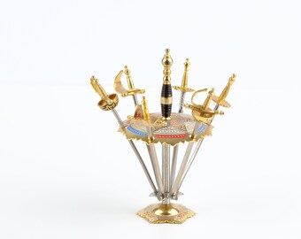 Six Toledo Cocktail Swords in a Stand