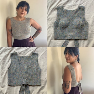 May include: A multicoloured crochet top with a tie at the back. The top is sleeveless and has a square neckline.