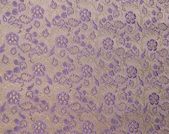 May include: Purple and gold floral patterned fabric with a textured surface.