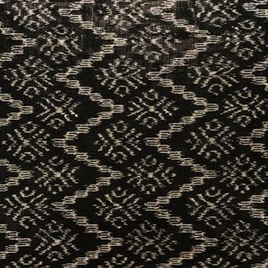 May include: Black fabric with a white geometric pattern. The fabric has a subtle sheen and a slightly textured surface.