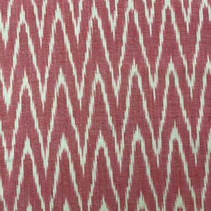 May include: Red and white ikat fabric with a wavy pattern. The fabric is woven with a white thread on a red background.