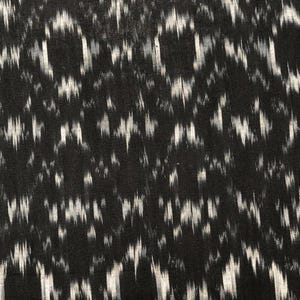 May include: Black and white ikat fabric with a repeating pattern of white lines on a black background.