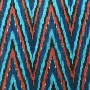 May include: Blue and red ikat fabric with a chevron pattern. The fabric has a woven texture.