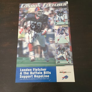 May include: A poster featuring a football player in a blue and red uniform with the text "London Fletcher & the Buffalo Bills Support HopeLine" and the Verizon Wireless logo.