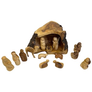 May include: A wooden nativity scene carved from olive wood. The scene includes a manger, a camel, a donkey, sheep, and figures of Mary, Joseph, and the baby Jesus. The figures are all hand-carved and painted in natural wood tones.