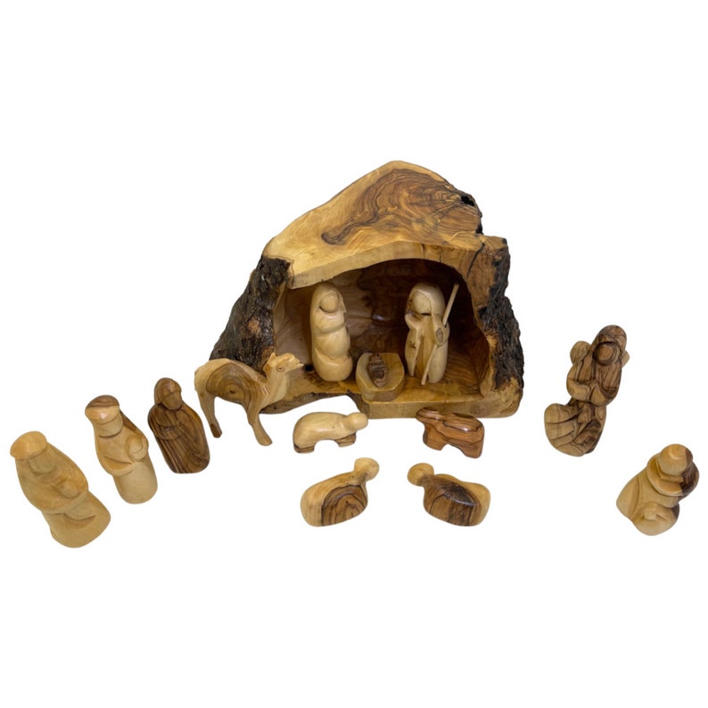 May include: A wooden nativity scene carved from olive wood. The scene includes a manger, a camel, a donkey, sheep, and figures of Mary, Joseph, and the baby Jesus. The figures are all hand-carved and painted in natural wood tones.