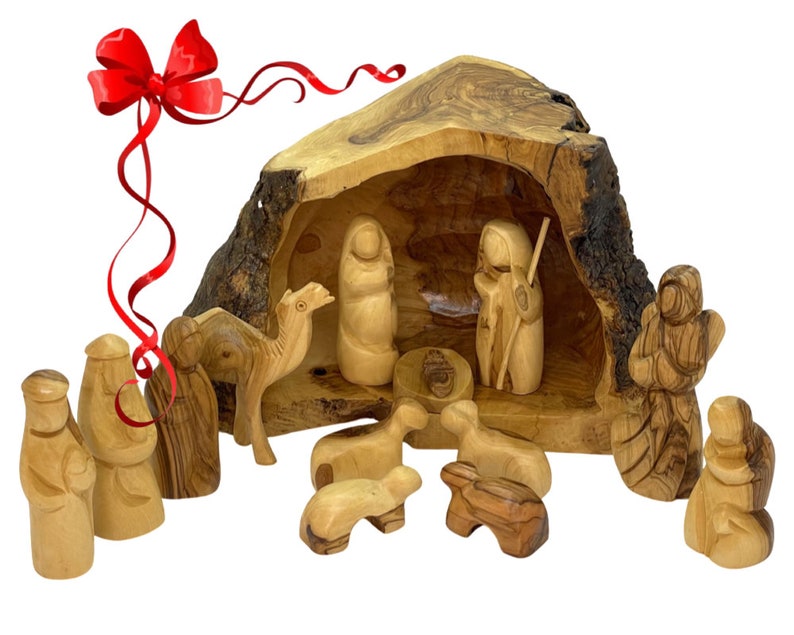 May include: A hand-carved olive wood nativity scene set with a manger, figures of Mary, Joseph, baby Jesus, a camel, sheep, and shepherds. The set is displayed in a hollowed-out olive wood log.