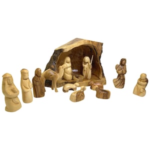 May include: A wooden nativity scene set with a carved olive wood manger, figures of Mary, Joseph, baby Jesus, a shepherd, an angel, three wise men, a camel, and two sheep.
